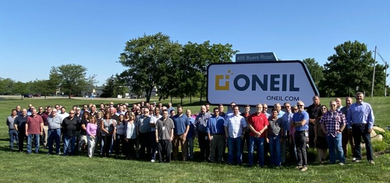 The ONEAL Team in front of new sign