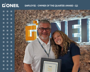 Melany receiving the employee of the quarter award from Hernan.